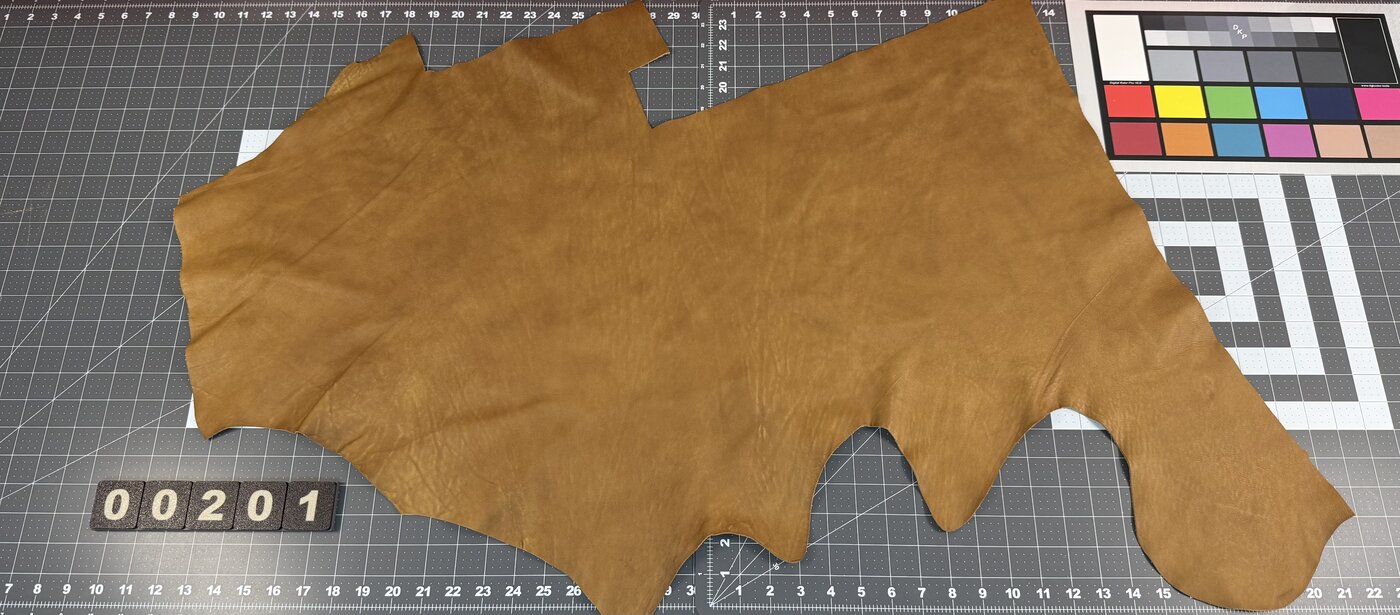 Example of a large tan leather piece on cutting mat with color correction card