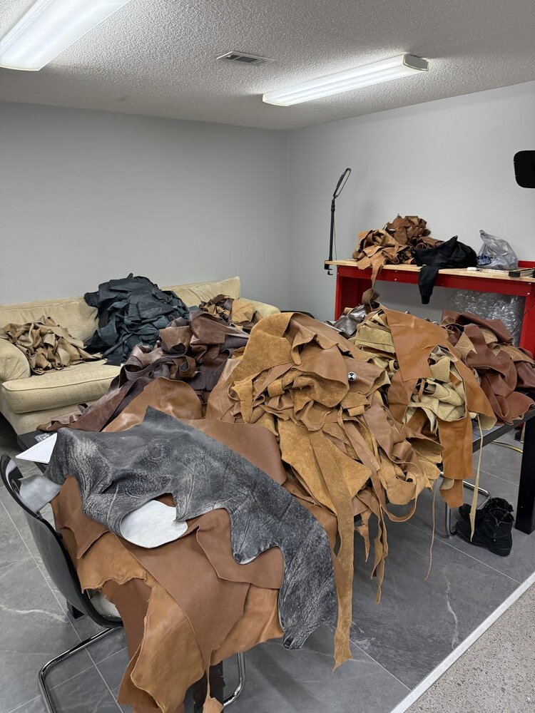 Workspace with sorted leather pieces in various colors